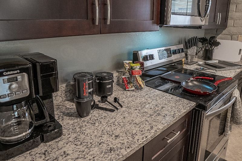 Coffee/Tea bar includes locally roasted ground coffee: regular & decaf. Prep options include a full pot brew, K-cup single serving pods & AeroPress (for best quality taste). Touch activated Koios electric kettle & tea selection for non-coffee drinks