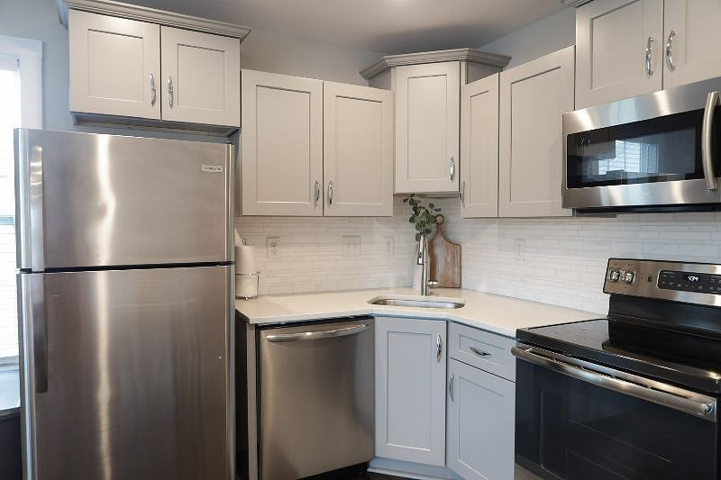 Full size, stainless steel refrigerator, microwave, oven, and dishwasher 