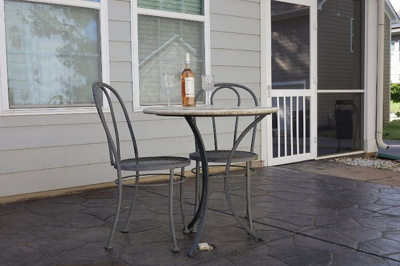 Shared outdoor patio space; this is now updated with a larger table and four chairs