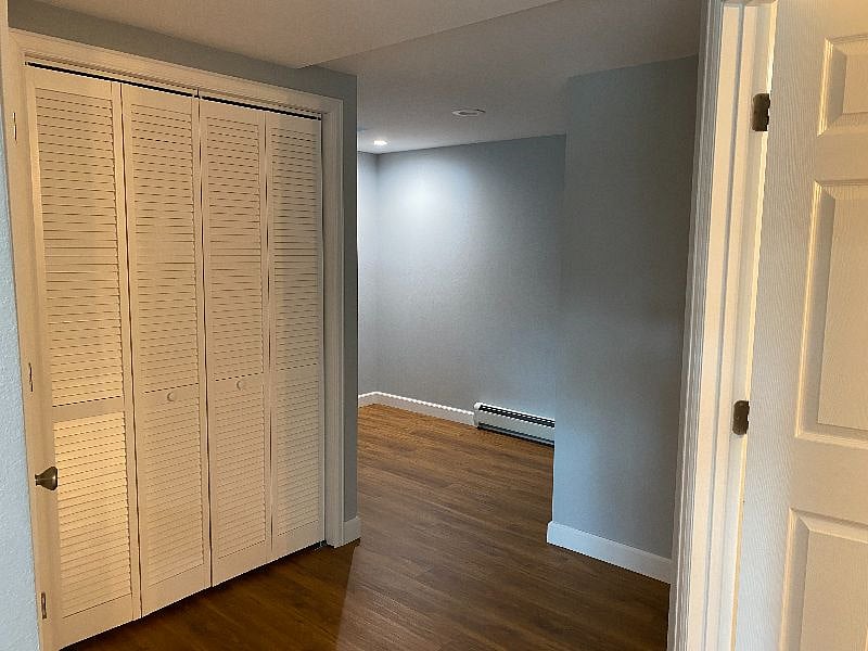 Closet with boiler and hot water heater.