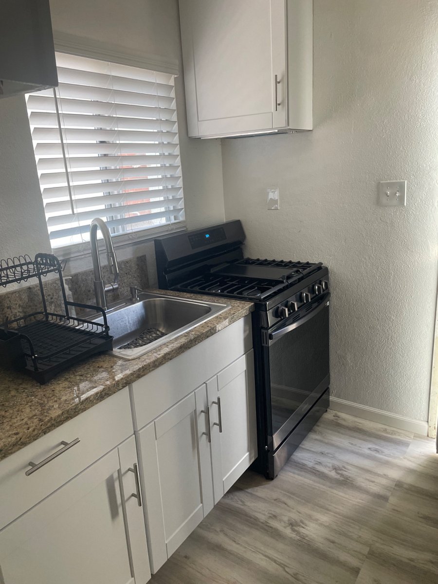 Full size kitchen including, full size stove and fridge.