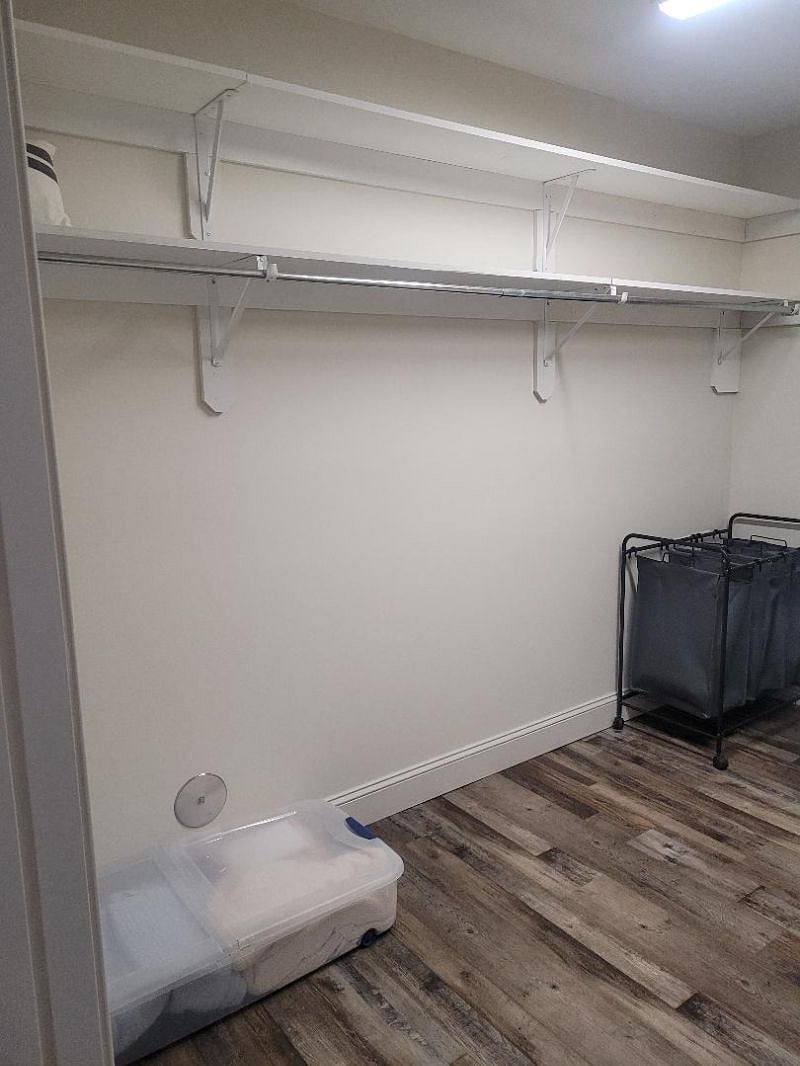 Shelf and clothes rack in master bedroom large walk-in closet