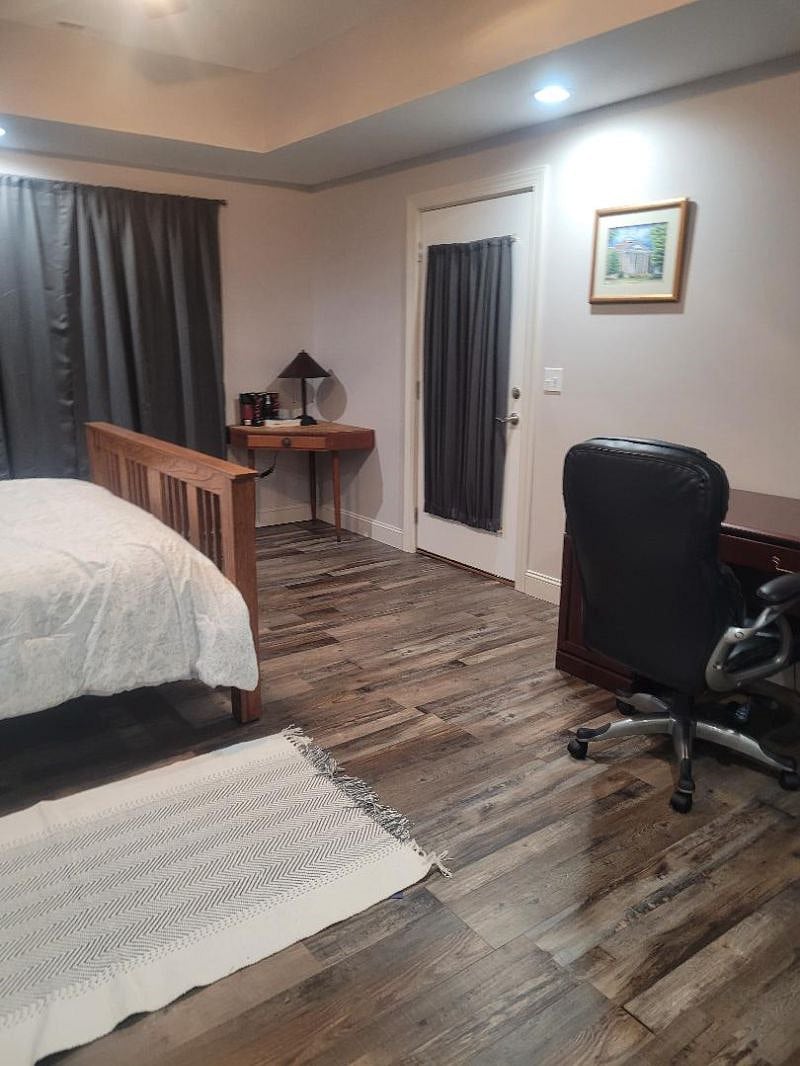 Door to outside from bedroom
Office desk and full-size office chair in bedroom