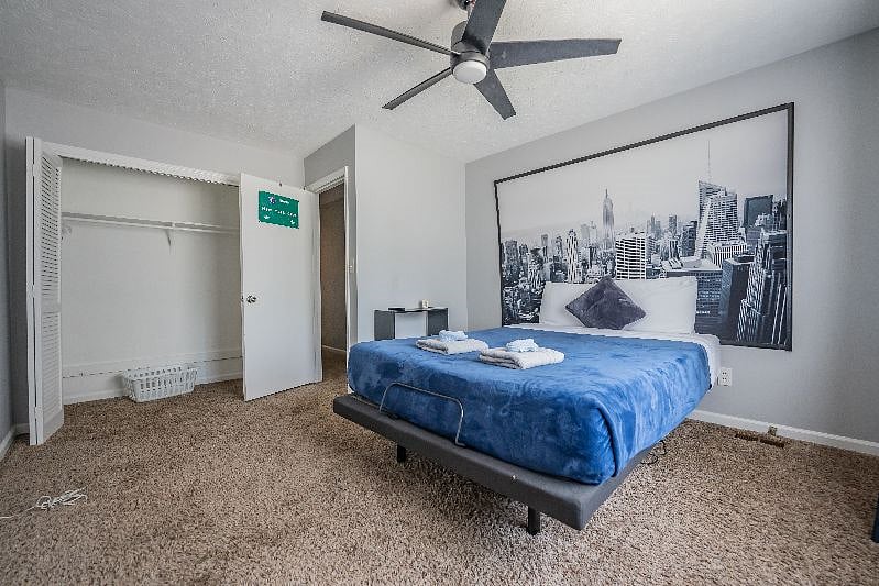 Inviting bedroom with a full-size bed, NYC-themed wall art, and a roomy closet.