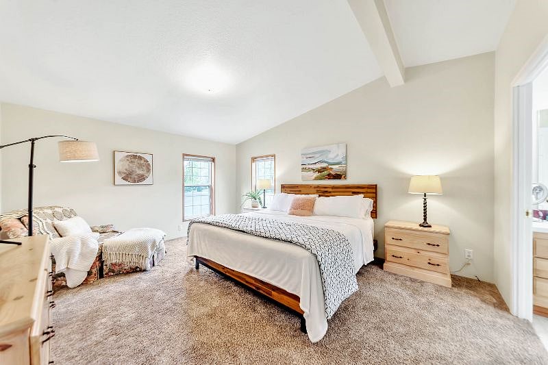 Primary bedroom suite king bed with walk-in closet and bathroom.