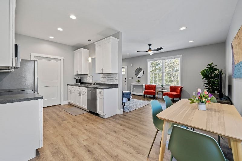 Alternate view of kitchen, dining, and living area.