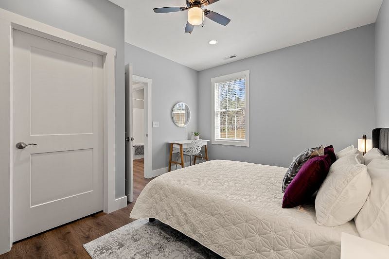 Alternate view of queen bedroom with desk and closet. You can see the access to the full bathroom just right out the bedroom door.