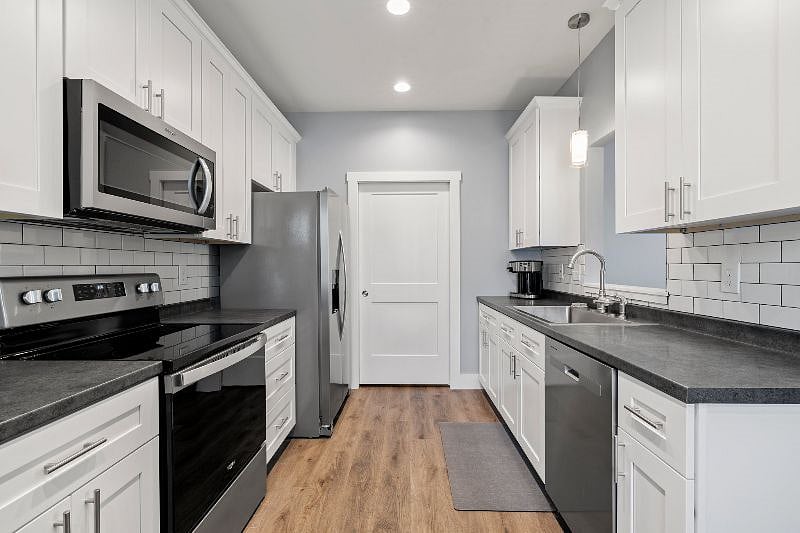 Full kitchen with everything you need, from dishes to pots and pans, to coffee and hot water maker and more.