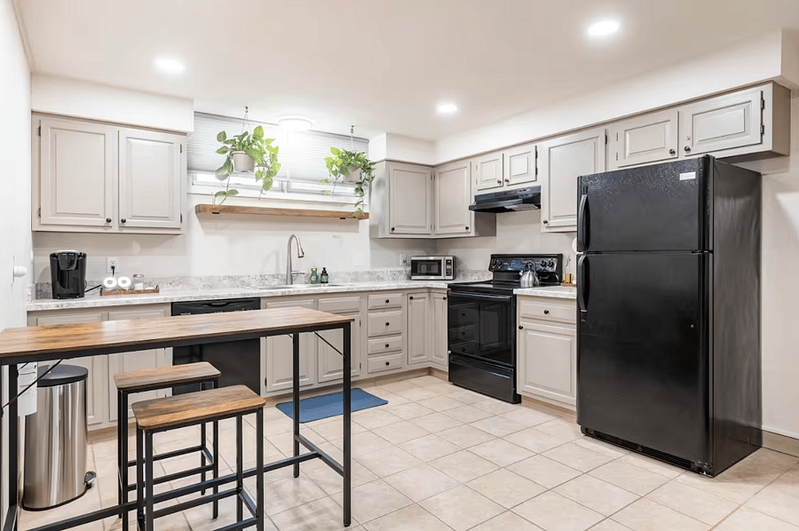 Full size kitchen equipped with the essentials, pots and pans, and starter cooking spices and oil.