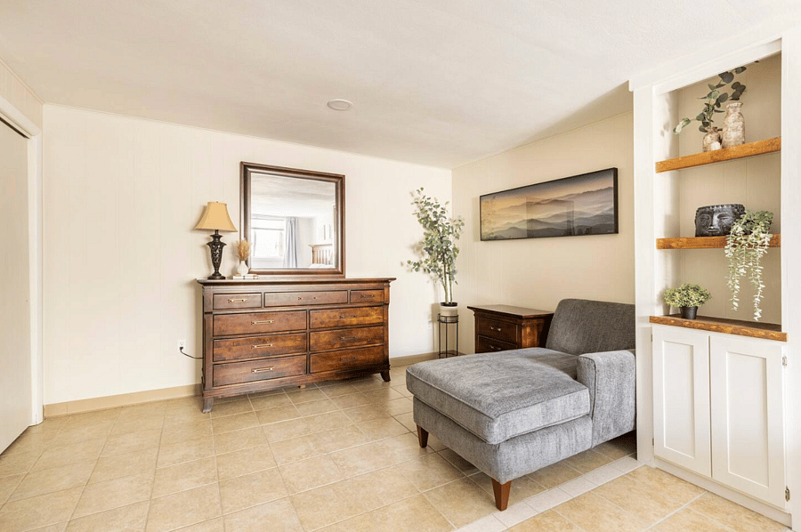 Dresser, chaise lounge chair, and end table, the perfect reading nook.