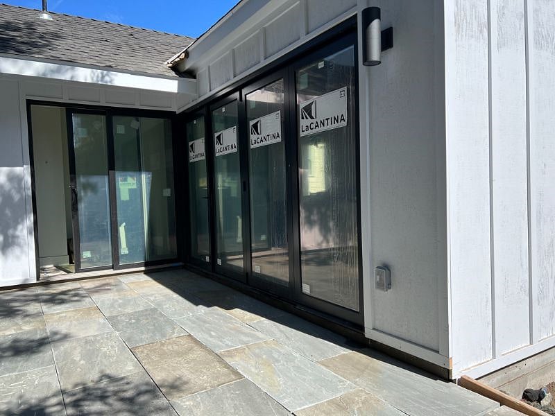 Accordian glass doors that fully open from great room to terrace. Photos still have stickers on windows for final inspection expected to be complete within a month. 