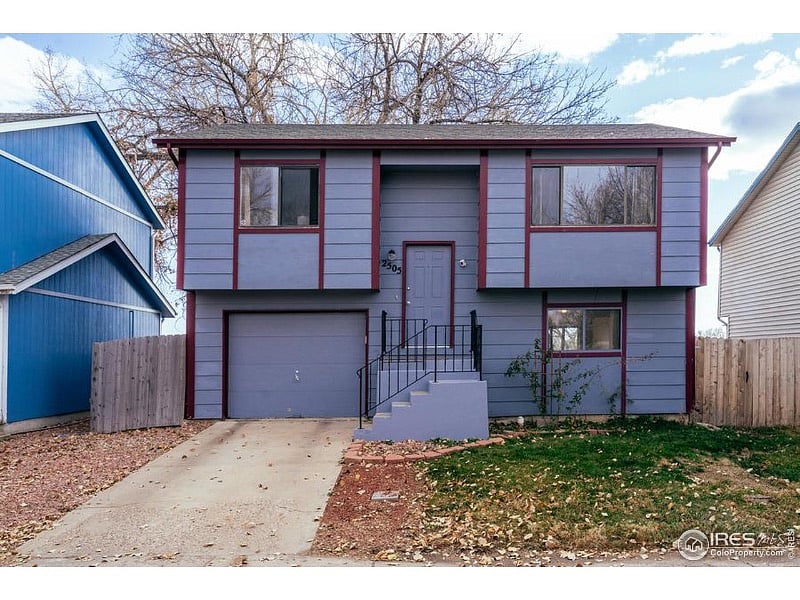Front of the house with parking on street or to left of driveway.