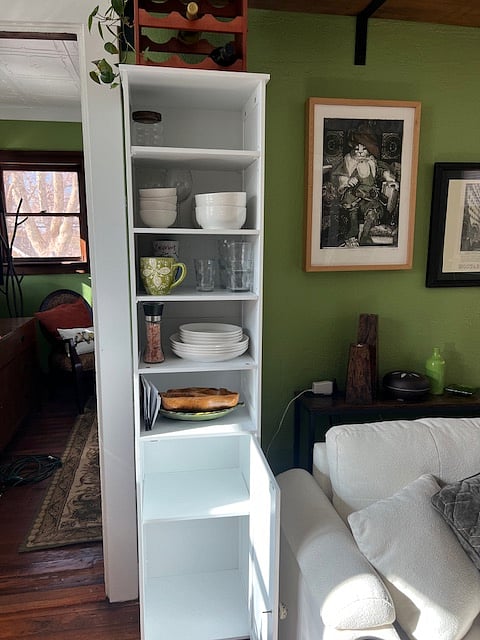 Fully stocked with glasses and dishware. Cabinet for food storage