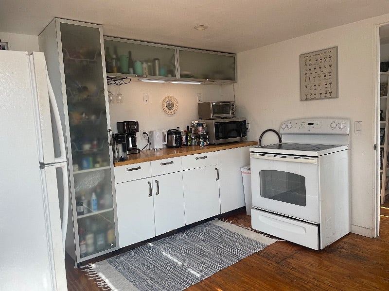 The entry-way to my apartment is through the door to the left. There is another, single-occupancy studio to the right. Both have their own private entrances and the kitchen is shared between myself and the individual who lives in the other unit. 