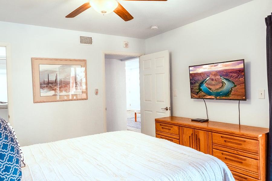 Bedroom TV with Direct TV. Room darkening draperies cover the patio entrance.
