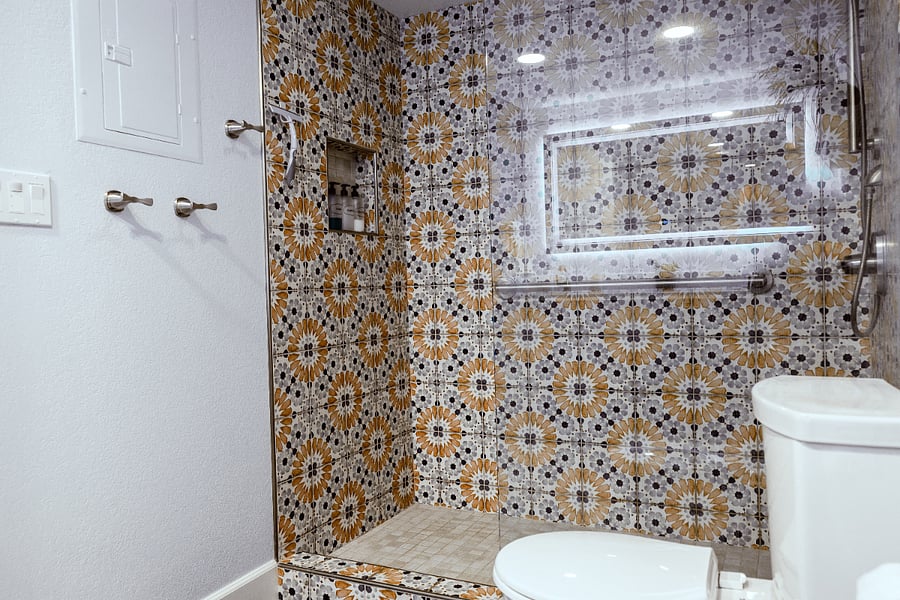 Step-in shower with grab bars for safety.