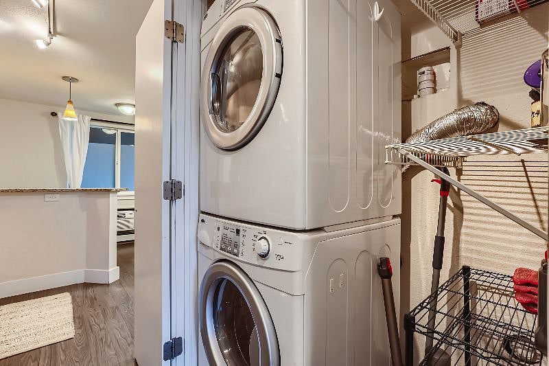 Washer and dryer in unit. This closet also includes other cleaning appliances (mop and vacuum).