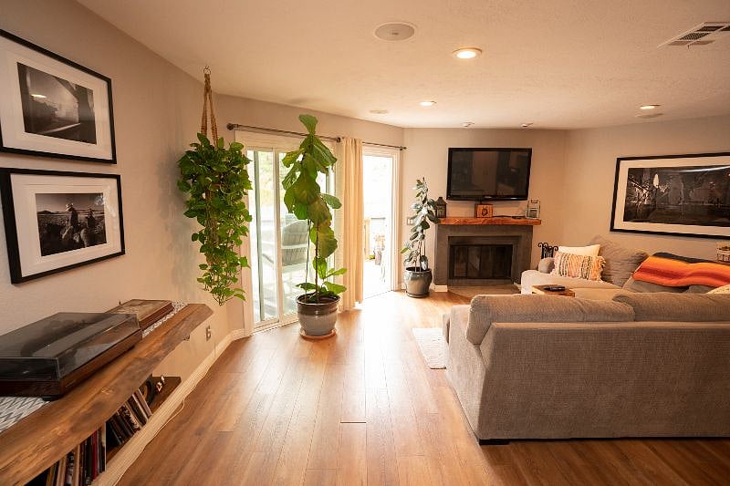 View of living room from front entry. Note large slider out to the fenced in patio.