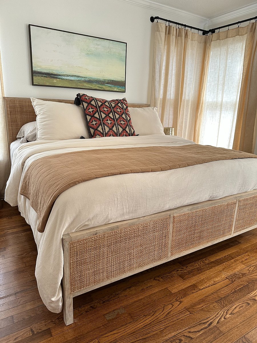 Primary king bedroom #1 with attached bathroom, luxury linens, and natural light
