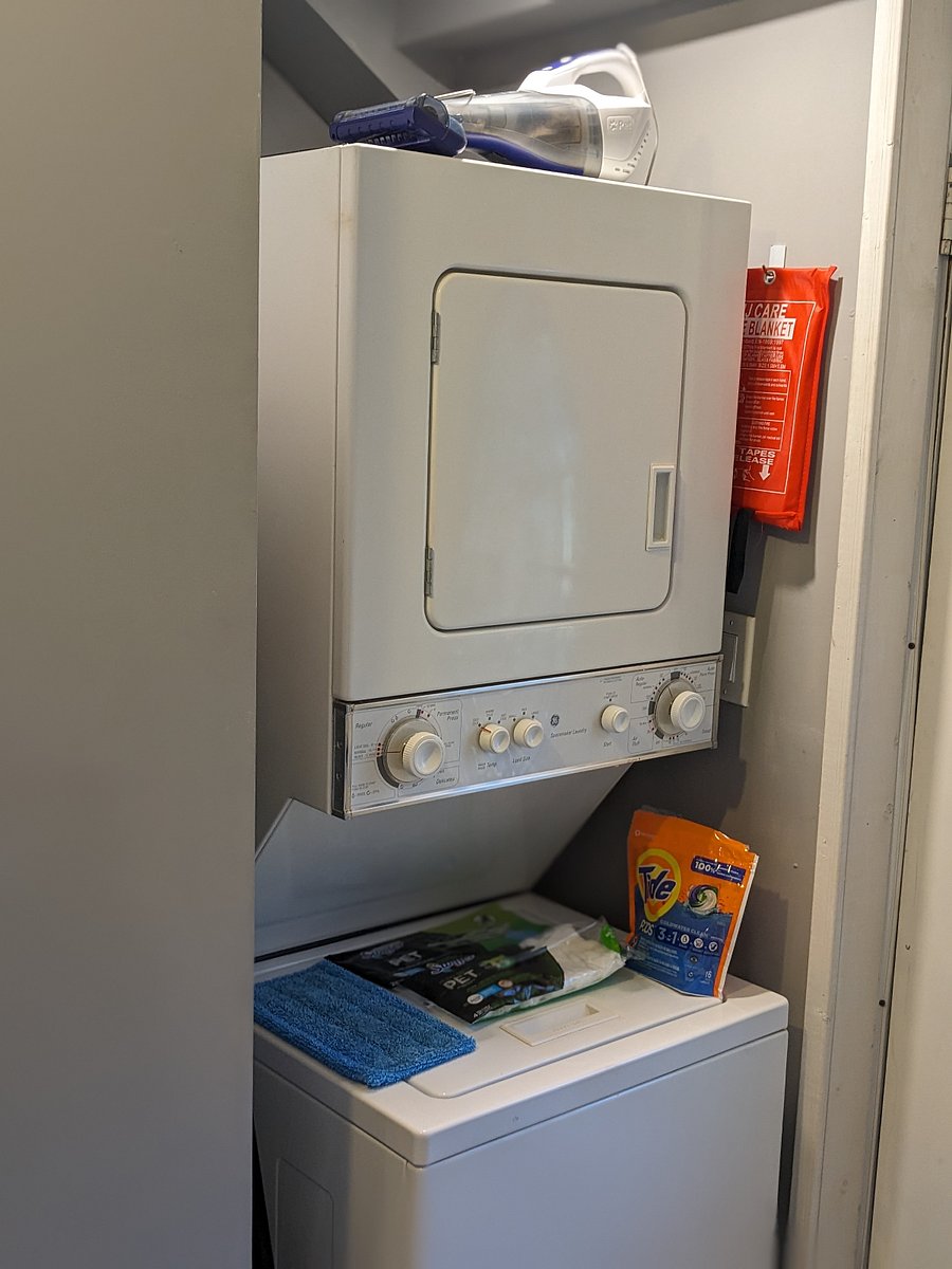 Stackable washer and dryer with starter supplies and hand vacuum.