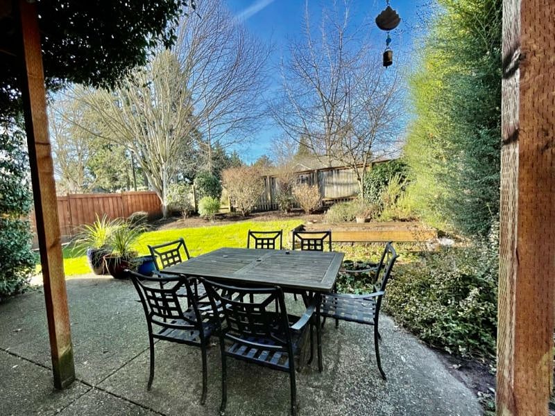 fully enclosed backyard with a BBQ
