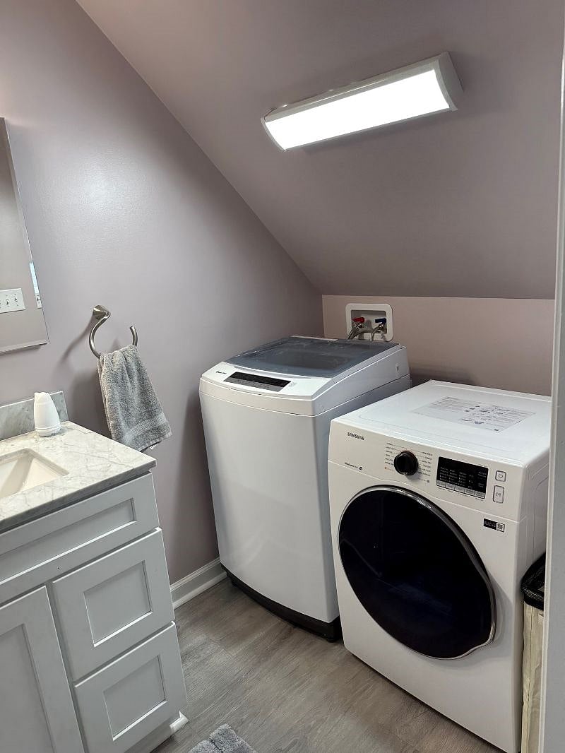 Bathroom/laundry room combined with rolling laundry baskets.
