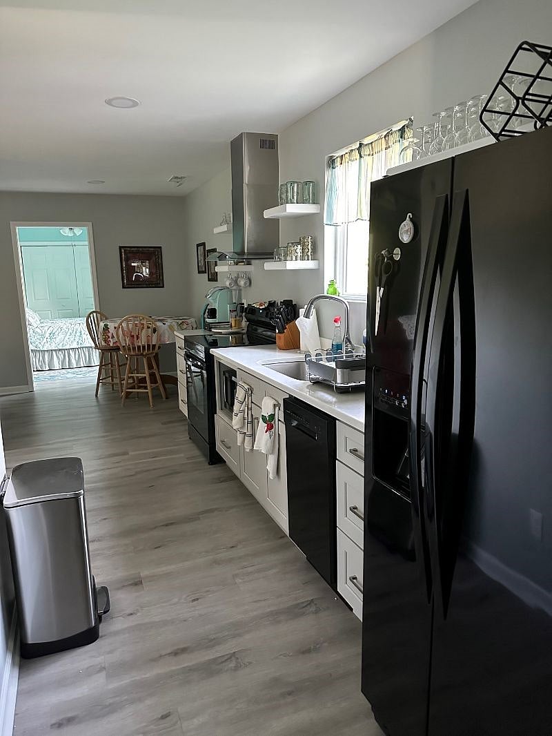 New appliances include dishwasher, microwave, full size refrigerator and cooktop stove.