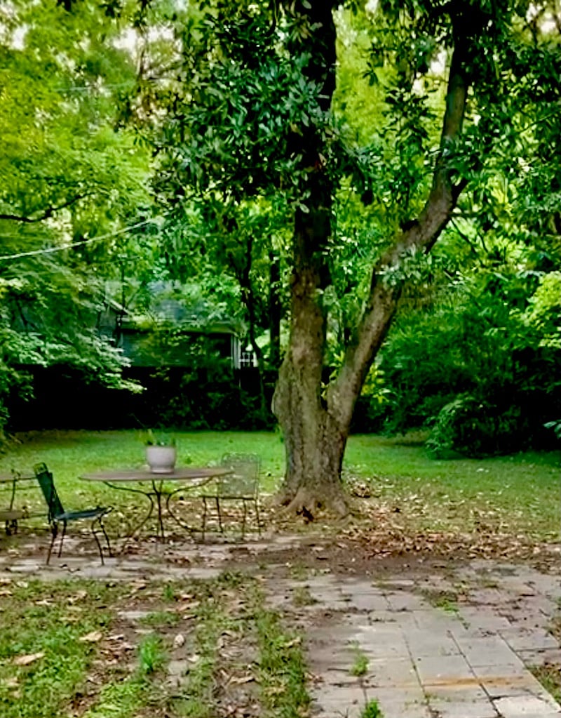 fenced-in back yard with seating area