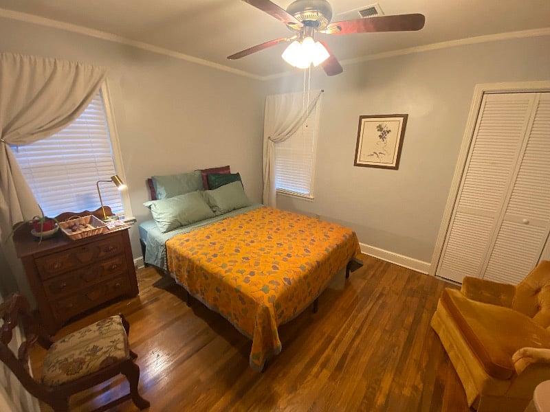 first bedroom - queen sized bed, black out curtains, large walk-in closet