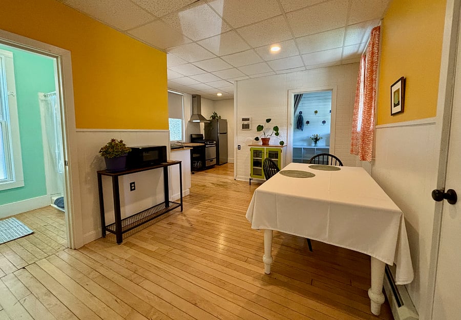 Dining room, kitchen and entrance to bathroom