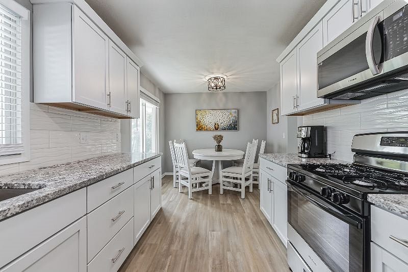 Kitchen with granite countertops and stainless-steel appliances, stocked with everything you need to feel at home.