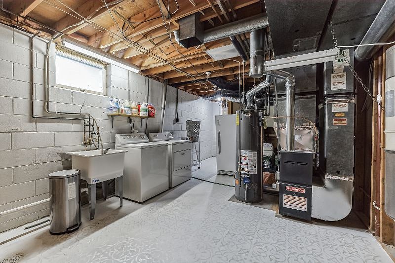 Lower level laundry room with washer, dryer, brackets, detergent supplied, vacuum cleaner, spot cleaner, and cleaning supplied.