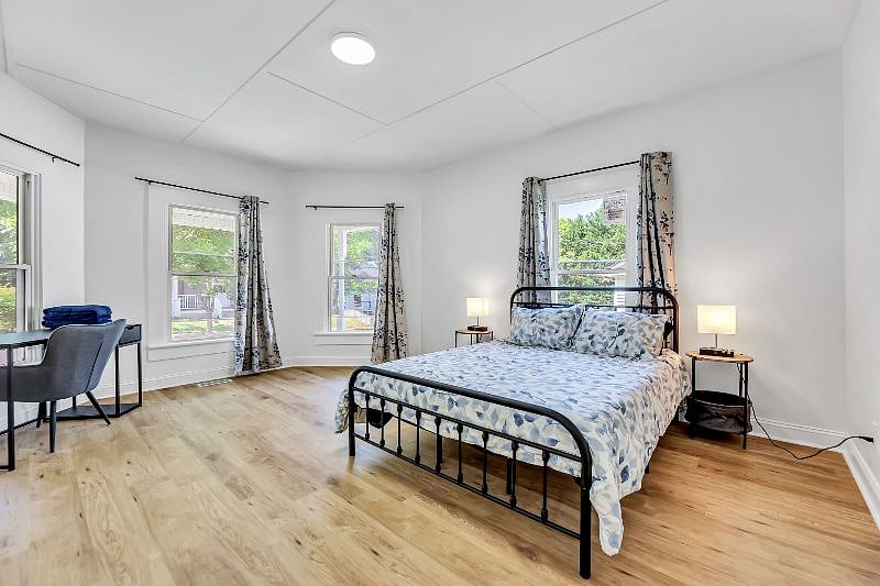 Large primary bedroom with desk, large closet, and ensuite bath