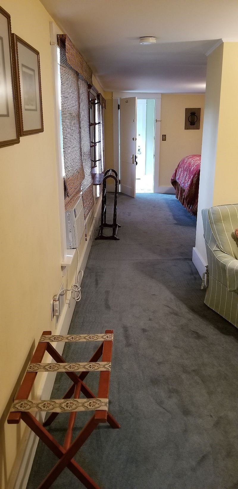 A half wall separates the bedroom from the sitting area