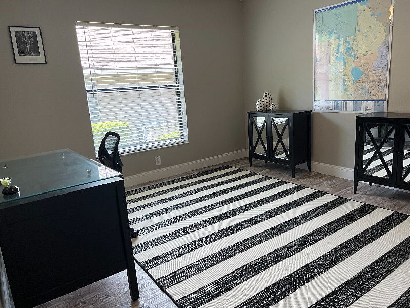 Third bedroom furnished as office with desk, chair and printer