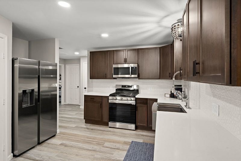 The kitchen features stainless steel appliances, farmhouse sink, walk-in pantry and a Keurig coffee station with a built in frother.