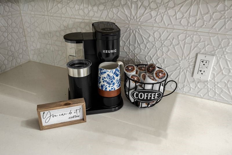 Coffee station with a built in frother and a starter supply of coffee pods.