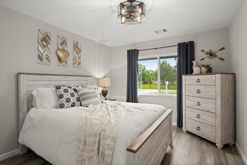 Queen size bed. Large window with black out curtains. Closet with shelves, hangers and laundry bag. Plus a tall dress for extra storage.