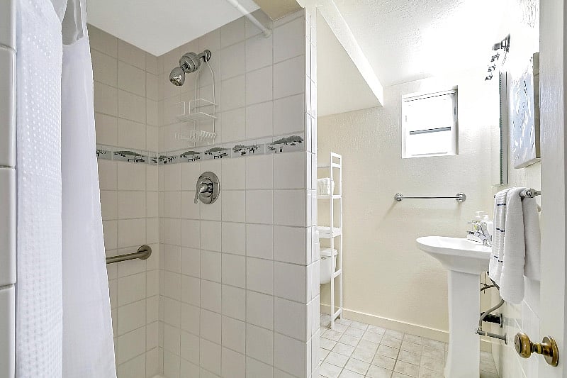 Bright bathroom with walk in shower.