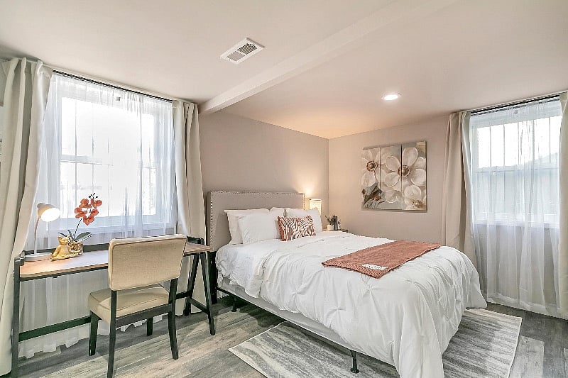 Spacious bedroom 2 with wall mounted flat panel smart TV.