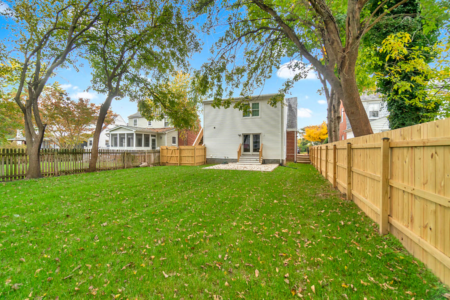 Beautiful, large, shaded, and grass-filled backyard.