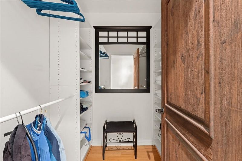 Master closet - additional area behind wood door on right. Shoe rack also in closet