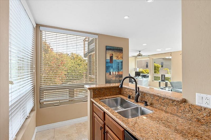 Kitchen sink area with views into the living room