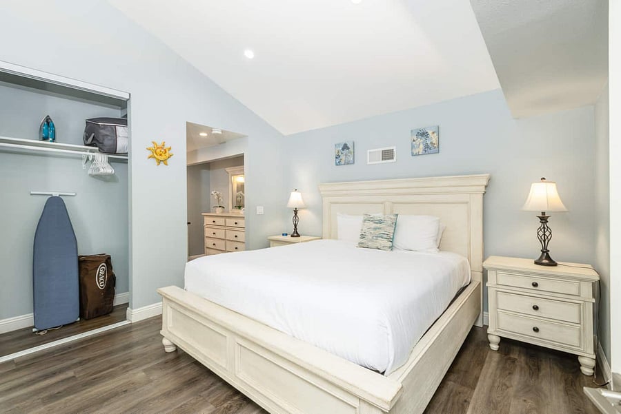 King bed in master bedroom. The house includes a Pack 'n Play, a vacuum, and an iron with an ironing board for your convenience.