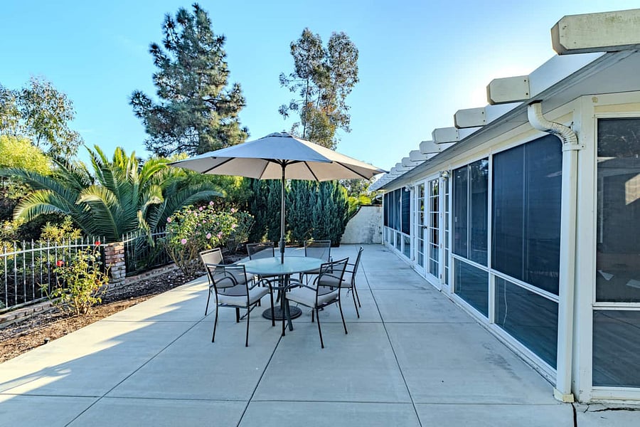 Relax in this gorgeous green backyard in front of a golf course.