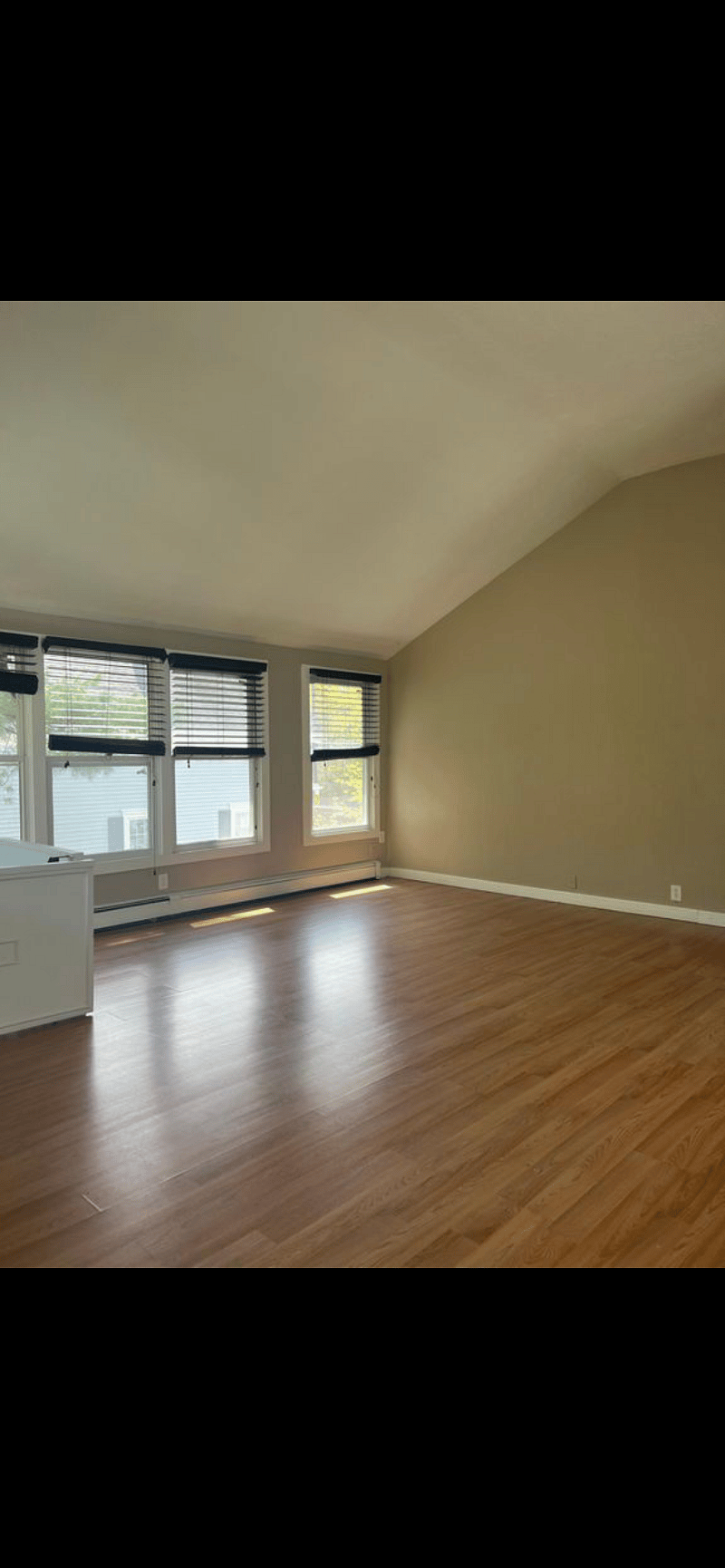 Same living space as previously shown to be furnished with sectional/ smart tv/ tv stand