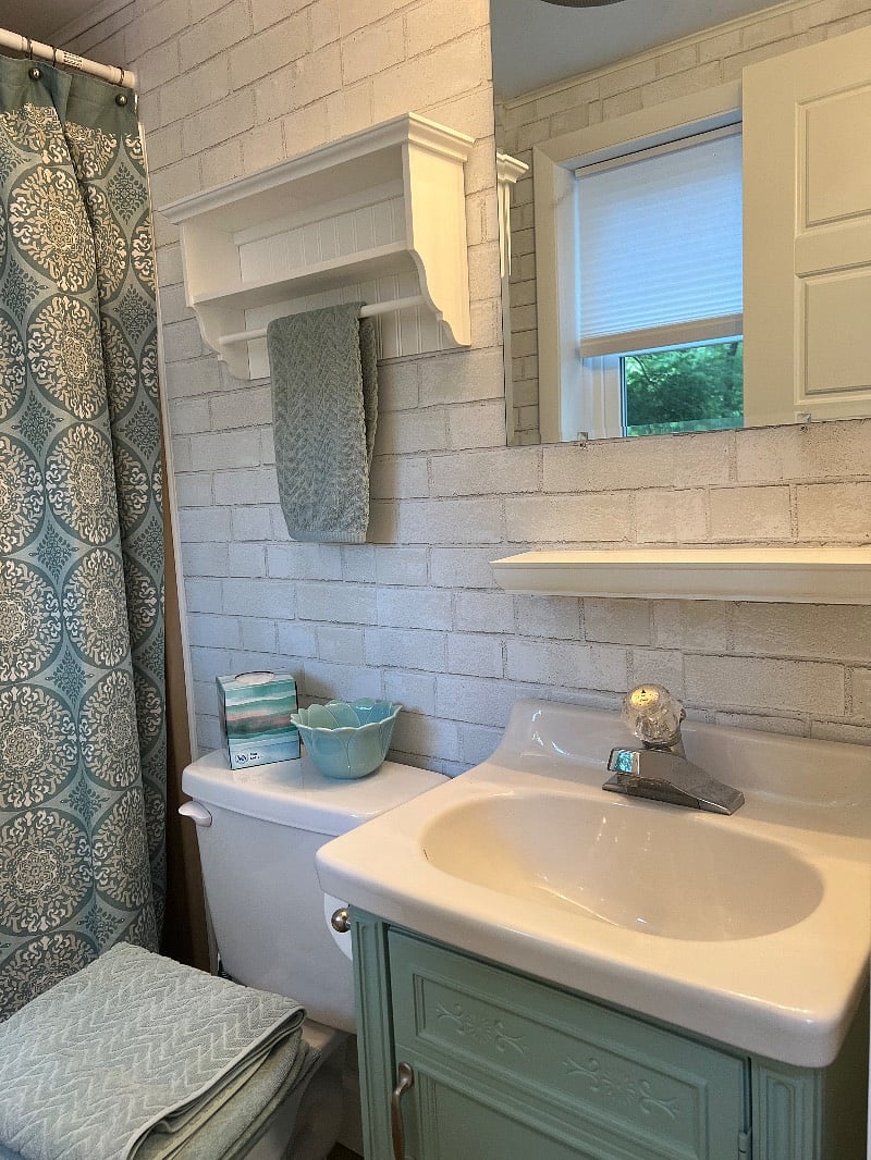 The bathroom shower and vanity were made to size and in good working order so they were not replaced - note older less modern faucet pictured here.