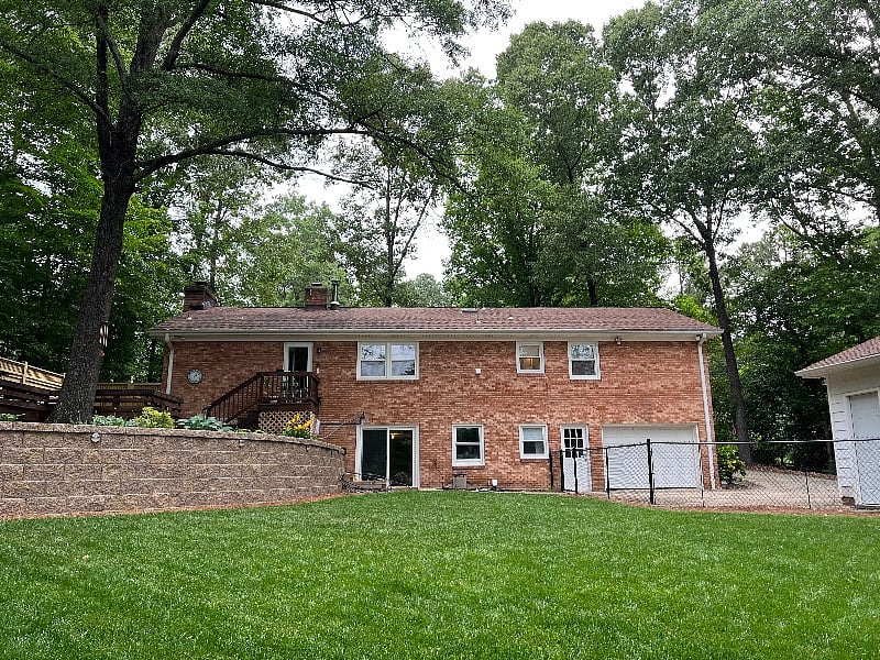 The single door to the left of the garage door is the entrance to the apartment.