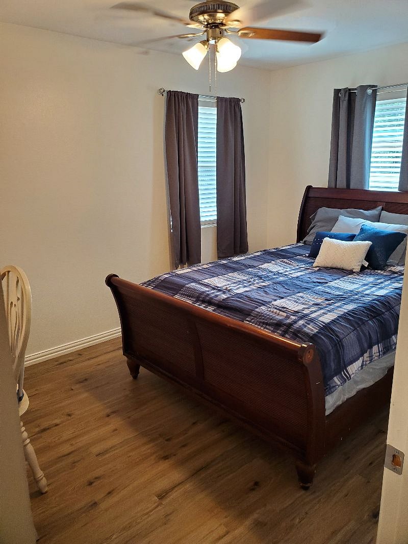 Bedroom one features a queen bed and a designated workspace