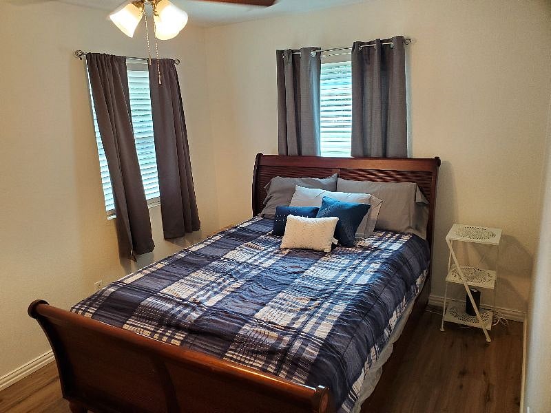 Bedroom one features a queen bed and a designated workspace